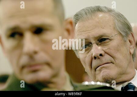 Chairman of the Joint Chiefs of Staff Gen. Peter Pace, U.S. Marine Corps, and Secretary of Defense Donald H. Rumsfeld listen to a committee memberís question as they testify before the House Armed Services Committee at the Rayburn House Office Building in Washington, D.C., on Feb. 16, 2006.  U.S. Army Chief of Staff Gen. Peter Schoomaker joined Rumsfeld and Pace in testifying before the committee. Stock Photo