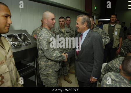 Secretary of Defense Donald H. Rumsfeld greets soldiers assigned to the 4th Infantry Division in Baghdad, Iraq, on April 26, 2006.  Rumsfeld and Secretary of State Condoleezza Rice will meet jointly with Iraq's newly designated Prime Minister Jawad al-Maliki to show support for the continuing process of building a new Iraqi government. Stock Photo