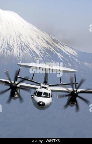 An E-2C Hawkeye aircraft assigned to Carrier Airborne Early Warning Squadron 115 flies past Mount Fuji in Japan on May 9, 2007. Stock Photo