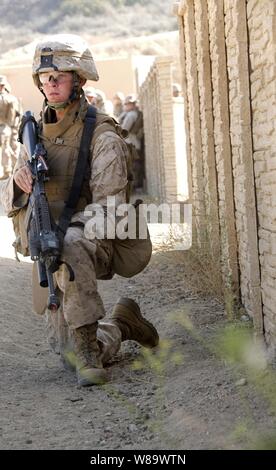 A U.S. Marine from Echo Company, 2nd Battalion, 1st Marine Regiment participates in an exercise at the simulated town, called combat town, at Camp Pendleton, Calif., on Aug. 12, 2008.  The exercise helps Marines prepare for real-world combat situations. Stock Photo