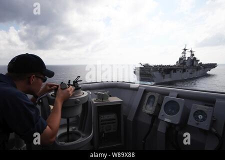 U.S. Navy Ensign Peter Larson uses an azimuth to find the heading to the amphibious assault ship USS Essex (LHD 2) from the landing dock ship USS Harpers Ferry (LSD 49) prior to a replenishment exercise with Essex in the Gulf of Thailand on Feb. 24, 2009.  The Harpers Ferry and Essex are forward deployed to Sasebo, Japan. Stock Photo