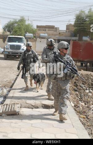 U.S. Army soldiers attached to 4th Battalion, 6th Infantry Regiment, 4th Brigade Combat Team, 1st Armored Division and soldiers attached to the provost marshalís office with Multi-National Corps - Iraq search for evidence of insurgency in a town in the Maysan province of Iraq on June 2, 2009. Stock Photo