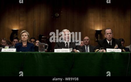 Secretary of State Hillary Rodham Clinton (left), Secretary of Defense Robert M. Gates and Chairman of the Joint Chiefs of Staff Adm. Mike Mullen (right), U.S. Navy, testify before the Senate Armed Services Committee regarding President Barack Obama's announcement that he is sending an additional 30,000 troops to Afghanistan in the Dirksen Senate Office Building in Washington, D.C., on Dec. 2, 2009. Stock Photo