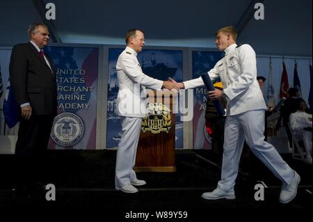 Chairman of the Joint Chiefs of Staff Adm. Mike Mullen and Secretary of Transportation Ray LaHood (left) congratulate midshipman Gary Taylor at the Seventy-Fourth commencement exercises at the U.S. Merchant Marine Academy in Kings Point, N.Y., on June 21, 2010.  As one of the five U.S. service academies, the USMMA is responsible for training midshipmen for service in the Merchant Marines, the maritime industries or the other five branches of the military, both at sea and ashore. Stock Photo