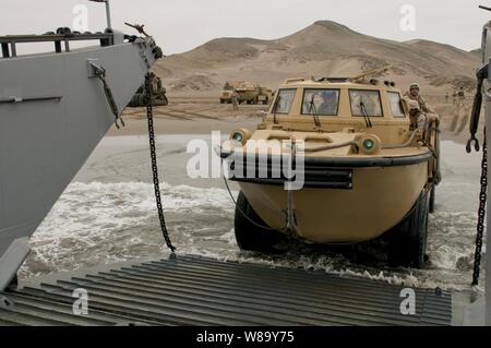 U.S. Navy Seaman Ashleigh Brown drives a lighter amphibious resupply cargo vehicle from Beach Master Unit 1 off of Salinas Beach, Peru, onto Landing Craft Unit 1617 during Amphibious-Southern Partnership Station 2010 on July 7, 2010. Stock Photo