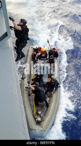 U.S. Navy sailors with a visit, board, search and seizure team from the guided-missile frigate USS Reuben James (FFG 57) board the fleet replenishment oiler USNS Guadalupe (T-AO 200) during exercise Koa Kai off the coast of Hawaii on Nov. 15, 2010.  Koa Kai is the primary integrated training event for mid-Pacific surface combatant units, encompassing Hawaii-based surface, submarine and aviation assets and other commands within the region. Stock Photo