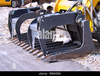 Grapple bucket a popular skid steer attachments used for loading and demolition Stock Photo