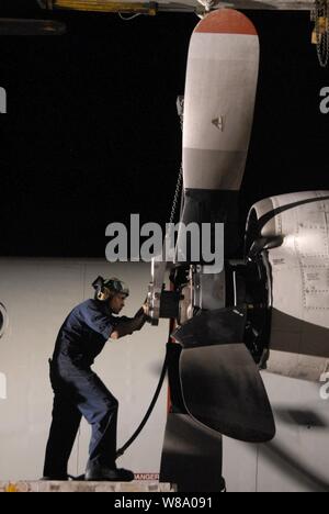 Petty Officer 2nd Class Omar Viraclass, assigned to Patrol Squadron 45, installs a propeller on the number two engine of a P-3C Orion aircraft in Sigonella, Sicily, on June 20, 2011.  Patrol Squadron 45 is deployed to Sicily supporting Operation Unified Protector. Stock Photo