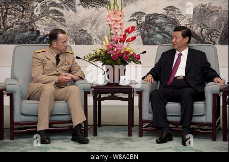 Chairman of the Joint Chiefs of Staff Adm. Mike Mullen speaks with Chinese Vice President Xi Jinping in Beijing on July 11, 2011.  Mullen is on a three-day trip to the country meeting with counterparts and Chinese leaders. Stock Photo