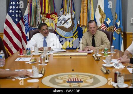 Chairman of the Joint Chiefs of Staff Adm. Mike Mullen speaks with new Secretary of Defense Leon E. Panetta during his first visit to the Tank to meet with the Joint Chiefs in the Pentagon on July 1, 2011. Stock Photo