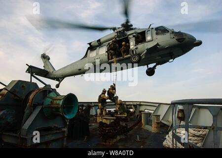 A U.S. Navy MH-60S Seahawk helicopter attached to Helicopter Sea Combat Squadron 28 conducts a shipboard extraction from an Italian Navy training vessel in the Gulf of La Spezia on March 13, 2012. Stock Photo