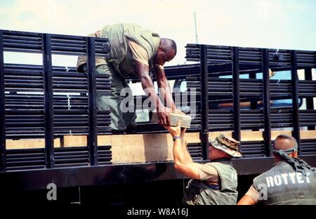 Marine Barracks Minefield Maintenance personnel unload deactivated anti-tank and anti-personnel land mines for destruction at a demolition site on Naval Station Guantanamo Bay, Cuba, in this March 18, 1997, file photo.  Anti-personnel and anti-tank land mines on the U.S. side of the fence separating Communist Cuba and the U.S. Naval Base at Guantanamo Bay are being removed in accordance with the Presidential Order of May 16, 1996.  Approximately 50,000 land mines were placed in the buffer zone between Communist Cuba and Guantanamo Bay beginning in 1961 as a result of the Cold War. The land min Stock Photo