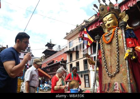 Lalitpur, Nepal. 08th Aug, 2019. A Buddhist devotee offers prayers to the idol of Buddha during Pancha Dan festival in Lalitpur, Nepal. (Photo by Archana Shrestha/Pacific Press) Credit: Pacific Press Agency/Alamy Live News Stock Photo