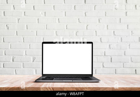 Modern computer,laptop with blank screen on white wall brick backgrounds Stock Photo