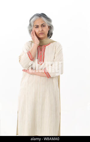 Senior woman thinking and looking sad Stock Photo