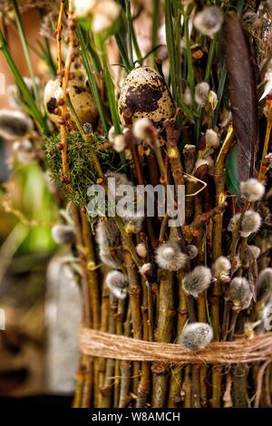 Willow branches woven into a bouquet. Decor. The concept of the traditional Russian holiday Palm Sunday. Close-up. Stock Photo