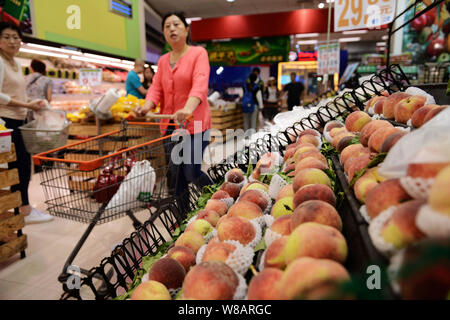 Chinese customers shop for fruits at a supermarket in Qingdao city, east China's Shandong province, 9 June 2016.   China's consumer inflation rose les Stock Photo