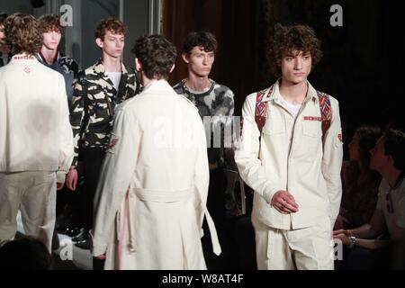 Models display new creations at the Valentino fashion show during the 2017 Spring/Summer Milan Men's Fashion Week in Milan, Italy, 22 June 2016. Stock Photo