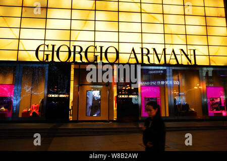 --FILE--A pedestrian walks past a Giorgio Armani store in Chongqing, China, 18 February 2016.   Italian fashion house Giorgio Armani experienced a slo Stock Photo