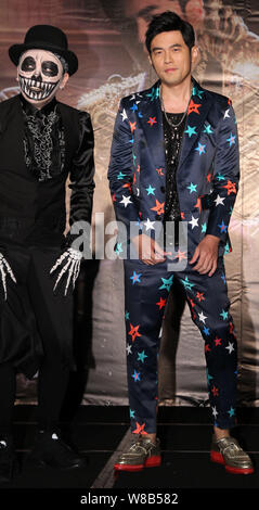 Taiwanese singer Jay Chou, right, poses at a press conference for his new music album 'Jay Chou's Bedtime Stories' in Taipei, Taiwan, 17 June 2016. Stock Photo