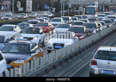--FILE--Vehicles move slowly in a traffic jam on a street in Beijing, China, 23 February 2016.   Beijing has preliminarily worked out policies on cong Stock Photo