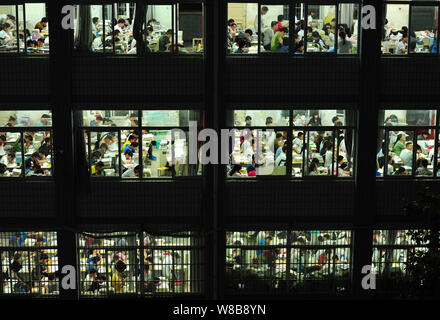 Chinese students review textbooks in preparation for the upcoming National College Entrance Exam, also known as gaokao, in their classrooms at the Fuy Stock Photo