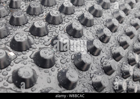 Rain drops on the surface of membrane waterproofing. Stock Photo