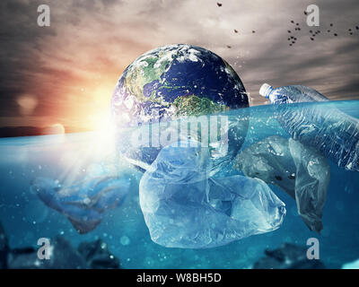 The Earth floats in the sea full of plastic. Save the World. World provided by NASA. Stock Photo