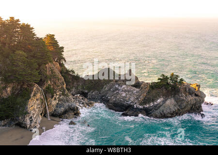 Warm morning light washing over McWay Falls along the Big Sur coastline in California. Stock Photo