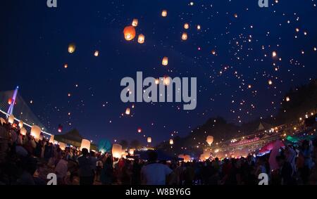 People release sky lanterns, also known as Kongming Lanterns, at the bank of Lancang River to celebrate the 1378th New Year of the Dai ethnic minority Stock Photo