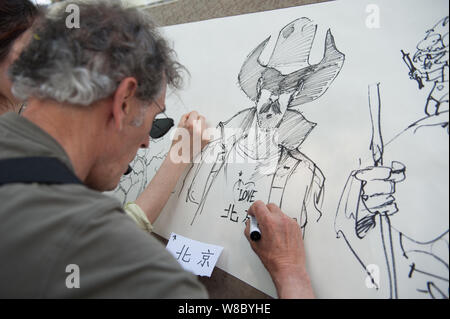 A foreign cartoonist draws pictures showing their impressions of Beijing during the 'Drawing Beijing - World Artists Illustrate Beijing' event at Shic Stock Photo