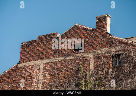 Backside old weathered vintage brick building wall facade Stock Photo