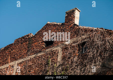 Backside old weathered vintage brick building wall facade Stock Photo