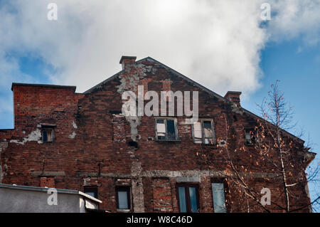 Backside old weathered vintage brick building wall facade Stock Photo