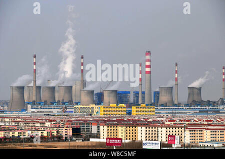 --FILE--Smoke and steam are discharged from chimneys and cooling towers at a coal-fired power plant in Zouping county, Binzhou city, east China's Shan Stock Photo