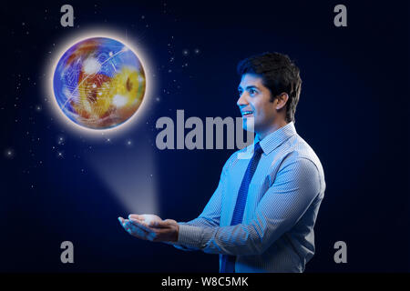 Businessman with a glowing globe of circuits Stock Photo