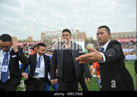 Brazilian football star Ronaldo Luiz Nazario de Lima, center, attends a football event in a high school in Mianyang city, southwest China's Sichuan pr Stock Photo