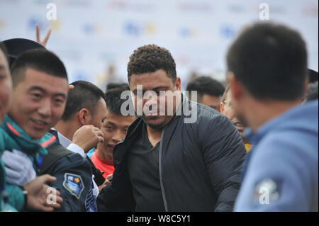 Brazilian football star Ronaldo Luiz Nazario de Lima, center, attends a football event in a high school in Mianyang city, southwest China's Sichuan pr Stock Photo