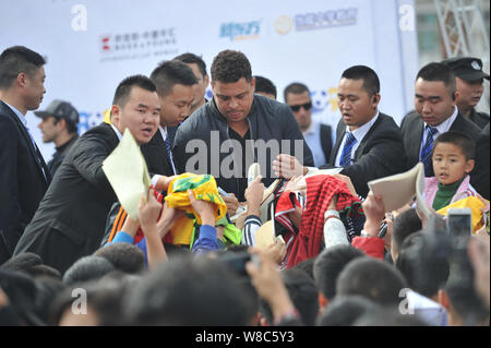 Brazilian football star Ronaldo Luiz Nazario de Lima, center, attends a football event in a high school in Mianyang city, southwest China's Sichuan pr Stock Photo