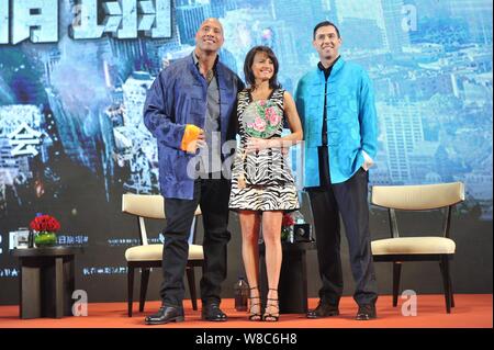 (From left) American actor Dwayne Johnson, also known by his ring name The Rock, actress Carla Gugino and Canadian director Brad Peyton pose during a Stock Photo