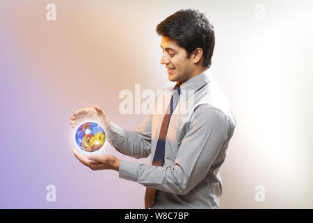 Businessman with a globe of circuits Stock Photo