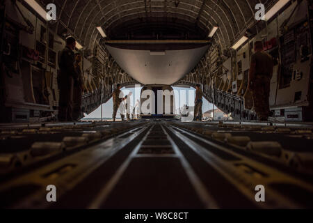 Airmen from the 89th Aerial Port Squadron load a Silver Bullet into a C-17 Globemaster III at Joint Base Andrews, Md., Aug. 1, 2019. The Silver Bullet provides safe, secure and tactical transport aboard C-17 cargo aircraft to U.S. senior leaders anywhere in the world. Using the Steel Eagle and it’s multiple communications systems, 89th Airlift Wing personnel are able to provide uninterrupted communications virtually anywhere around the globe.  (U.S. Air Force Photo/Tech. Sgt. Robert Cloys) Stock Photo