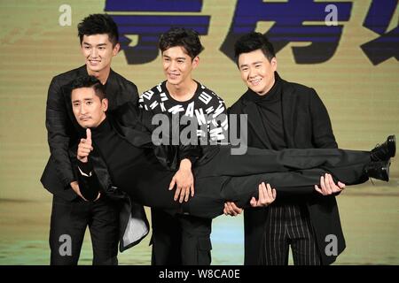 South Korean actor Shin Hyun-joon, front, is held by (from left) Chinese actors Yang Xuwen, Qiao Zhenyu and Ding Wenbo at a press conference for their Stock Photo