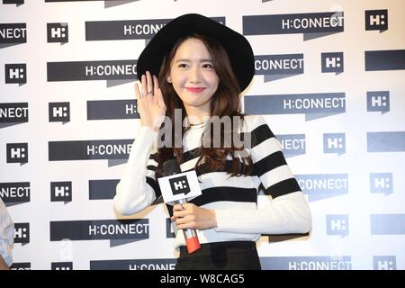 Singer and actress Im Yoona of South Korean girl group Girl's Generation waves during the opening ceremony for a store of South Korean brand H:CONNECT Stock Photo