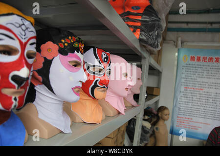 Peking Opera facekini masks by Chinese facekini designer Zhang Shifan are on display at her stand during the 13th China International Marine Fair and Stock Photo