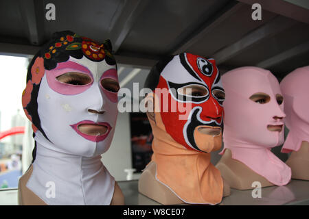 Peking Opera facekini masks by Chinese facekini designer Zhang Shifan are on display at her stand during the 13th China International Marine Fair and Stock Photo