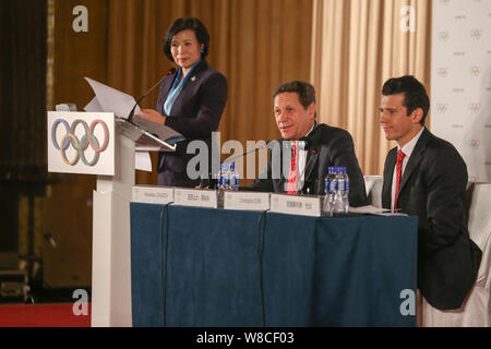 Alexander Zhukov, center, head of the 2022 Evaluation Commission for the International Olympic Committee (IOC), speaks next to Christophe Dubi, right, Stock Photo