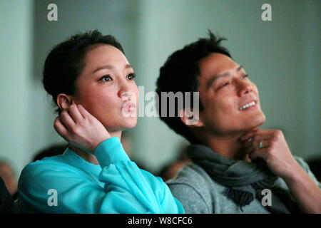 Chinese actress Zhou Xun, left, and her American actor husband Archie Kao watch the micro film 'Dream Escape' during a premiere event for the film to Stock Photo