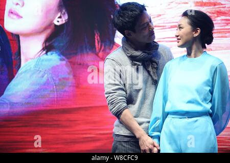 Chinese actress Zhou Xun, right, and her American actor husband Archie Kao look at each other during a premiere event for the micro film 'Dream Escape Stock Photo