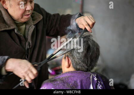Chinese Barber Wang Weimei Left Uses A Pair Of Hot Fire Tongs To